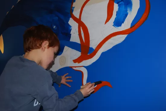 Nick painting the tentacles of the giant squid wall mural